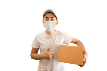 Young Asian delivery man wearing cap and white blank t-shirt holding parcel post box on transparent background - PNG format.