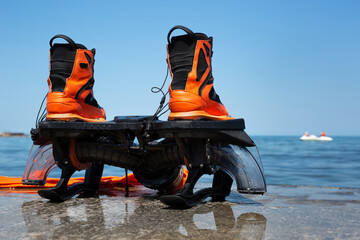 Shoes for a flyboard on the seashore.
