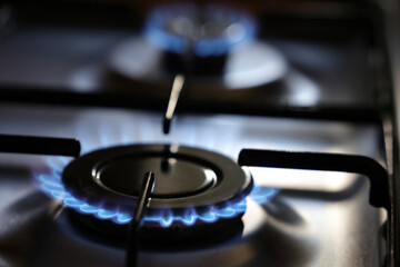 Natural Gas is burning in gas-stove in the kitchen. Concept for problems with natural gas in Europe.