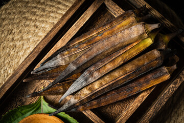 Charcoal roasted okra on a dark background