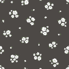 Calico millefleurs seamless pattern. Small white summer wildflowers in a simple hand drawn cartoon style on a black background. Ideal for textile, fabric, surface, wallpaper, scrapbooking, wrapping.