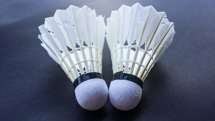 Badminton shutter cocks on racket are on dark background