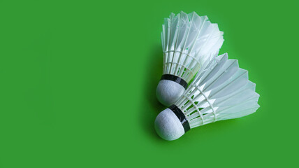 Badminton shutter cocks on racket are on green background