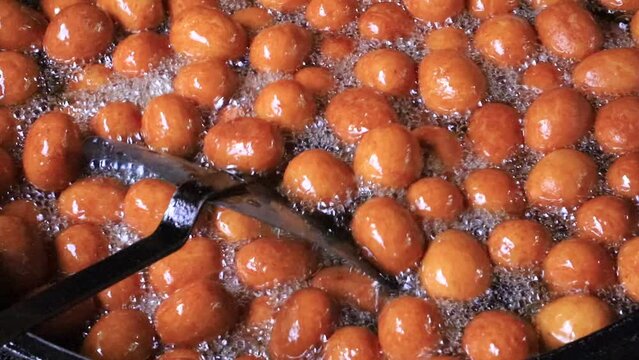 Red Sweet Rosogolla Gulab Jamun Making is A Bangladeshi Traditional food 