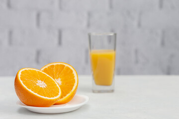 Sliced orange on a saucer with a glass of orange juice