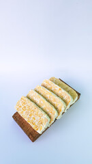 Tempeh in sliced on a cutting board