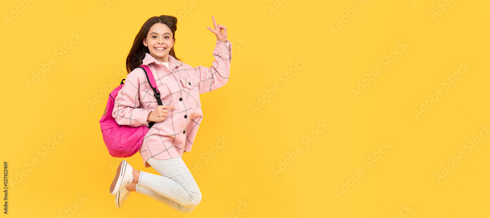 Wall mural happy child girl wear pink checkered shirt jumping school backpack, full of energy. Banner of school girl student. Schoolgirl pupil portrait with copy space.