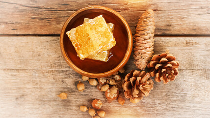 Honey and honeycomb with wooden spoon  on wooden table