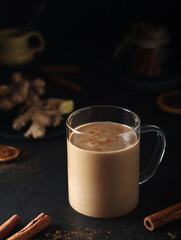 A cup with masala chai in low key	