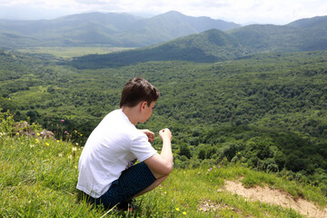 Fototapeta na wymiar Portrait of boy on Azish-Tau ridge background