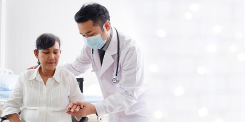 Male doctor caring for patients in hospital medical care concept.