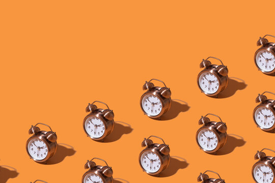 Pattern of an alarm clock on a colored background. Monochrome time concept