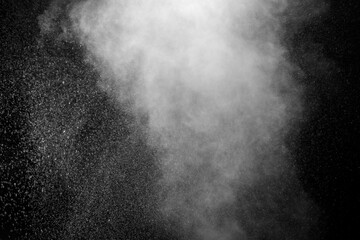 Curly white steam rising up and splashing water scattering in different directions isolated on a black background to overlay. Evaporation of liquid and condensation. Can be used as design element