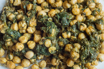Close-up overhead view of a traditional chickpea and spinach tapa.