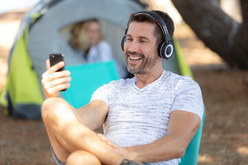 happy young man tourist sitting  using cell phone