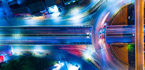 Expressway top view, Road traffic an important infrastructure,car traffic transportation above intersection road in city night, aerial view cityscape of advanced innovation, financial technology	