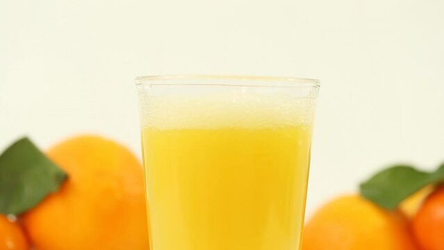 This refreshing stock photo showcases juicy oranges and freshly squeezed juice on a clean white background, perfect for health, wellness, and food-related content.