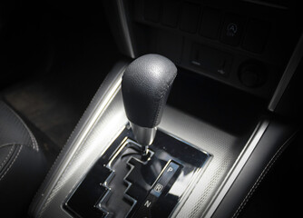 Automatic gear stick of a modern car in drive position, car interior details, close up view