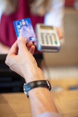 close up of hand using credit card machine to pay