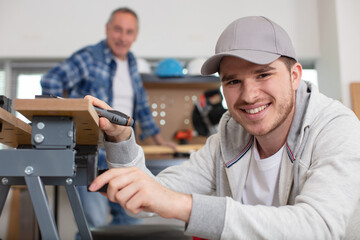 Fototapeta premium young worker is fixing a table