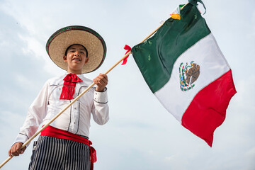 Young boy holding flag of Mexico