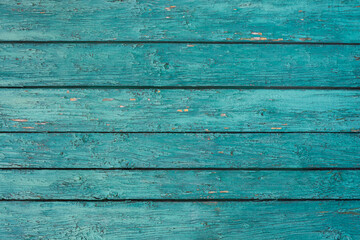 Wood background texture. Wooden surface, old boards, blue-green paint, blank retro template for advertising lettering, rough material, grungy textured background closeup.