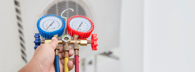 Technician checking the operation of the air conditioner