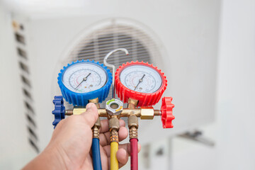 Technician checking the operation of the air conditioner