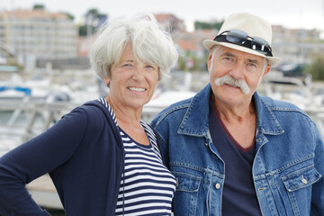 senior couple walking on a port