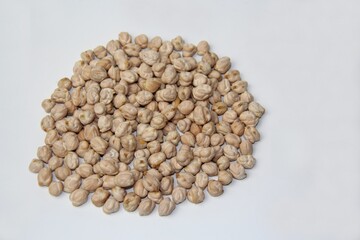 Chickpeas (Cicer arietinum) stacked on a white background, top view. It is also known by the names: Gravanço, Herbanzo, Chicken Pea or Bengal Pea or Duck Grain.