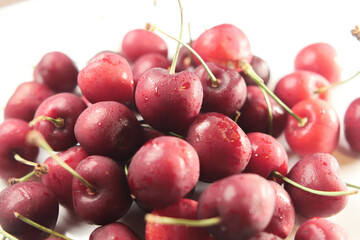ripe fresh cherry on a white tray 