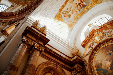 Vienna, Austria - August 27, 2022: Inside of a beautiful roman catholic church. Ceiling with...