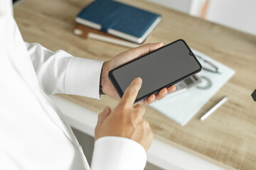 Business man using telephone to communicate business investment, man in white shirt standing in office