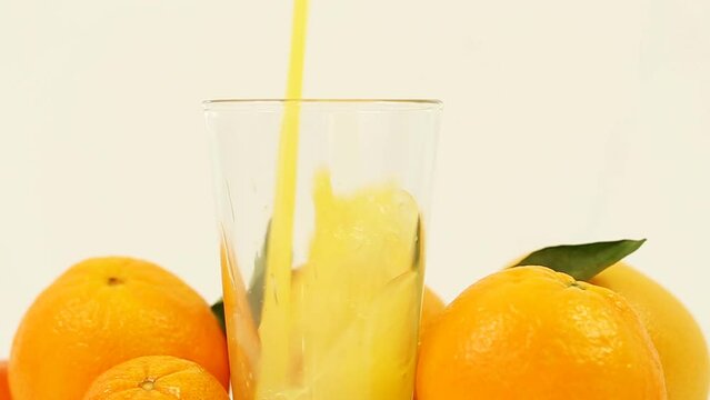 This refreshing stock photo showcases juicy oranges and freshly squeezed juice on a clean white background, perfect for health, wellness, and food-related content.