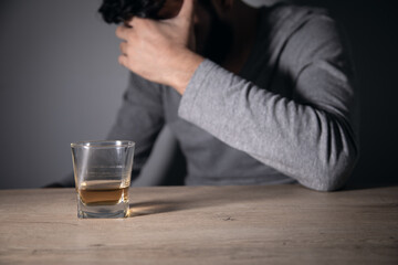 sad man hand glass of whiskey