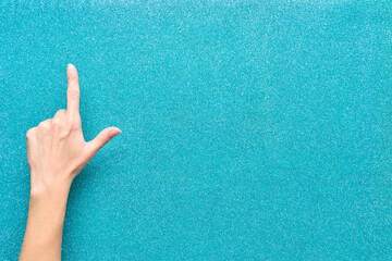 hand in the sky on turquoise bright background