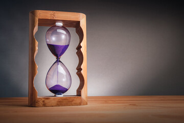 Hourglass on wooden table