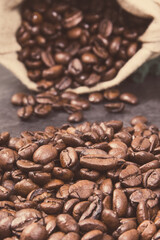 Dark roasted fragrant coffee beans in jute bag