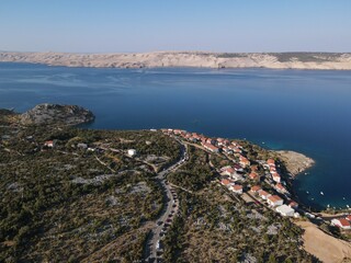 Aerial view of Prizna, Trajekt Prizna-Zigljen to reach the island of Pag. Drone view of queue to catch ferry for Pag. Small town with turquoise water on the hill of Croatia, in Dalmatia.