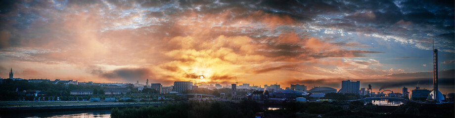 Fototapeta na wymiar Dramatic sunrise sky over urban landscape of Glasgow Scotland