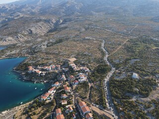 Aerial view of Prizna, Trajekt Prizna-Zigljen to reach the island of Pag. Drone view of queue to catch ferry for Pag. Small town with turquoise water on the hill of Croatia, in Dalmatia.
