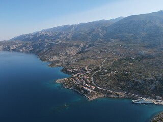Fototapeta premium Aerial view of Prizna, Trajekt Prizna-Zigljen to reach the island of Pag. Drone view of queue to catch ferry for Pag. Small town with turquoise water on the hill of Croatia, in Dalmatia.