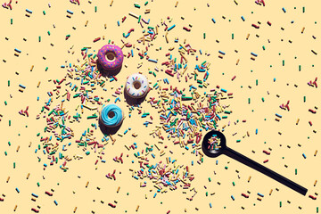 Trendy sunlight seamless pattern made of three colorful doughnut toys and sprinkle candy with sharp shadow on vivid yellow background. Minimal food summer concept with copy space.
