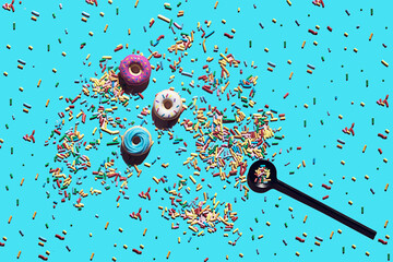 Trendy sunlight seamless pattern made of three colorful doughnut toys and sprinkle candy with sharp shadow on vivid blue background. Minimal food summer concept with copy space.