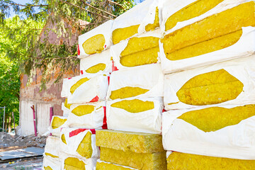 Stack of thermal insulation material is wrapped with cellophane foil