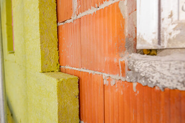 View at unfinished thermal wall of unfinished residential building, insulation material, rock wool