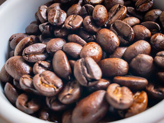close up of a cup with brown coffee grains	