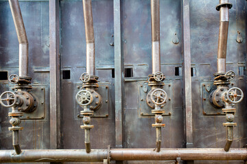 Valves, copper pipes. Old stove. Industrial, metal, mechanical factory background. Loft