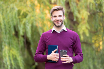 Fototapeta premium happy young handsome man drink morning coffee outdoor