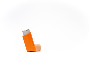 Side view of an orange aerosol spray canister inside leaving copy space. Basic and necessary tool for patients with asthma and similar diseases. Respiratory health concept.